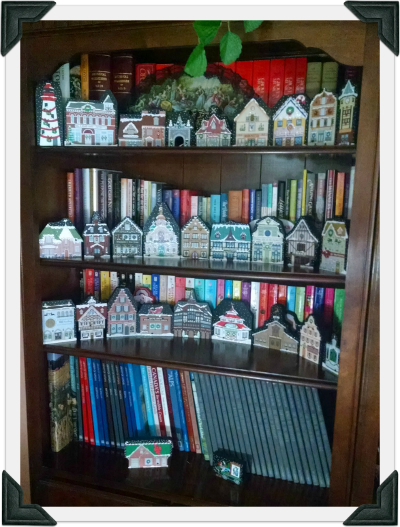 A bookcase in Chris' home decorated with Christmas Cat's Meows