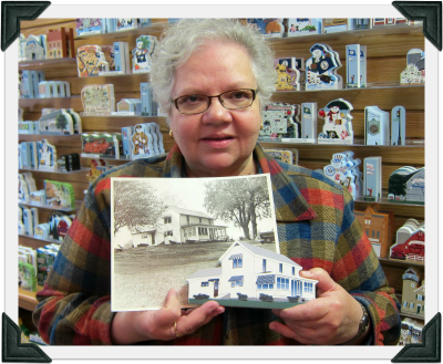 Chris holds a Cat's Meow replica of her home along with the photo she provided our designer