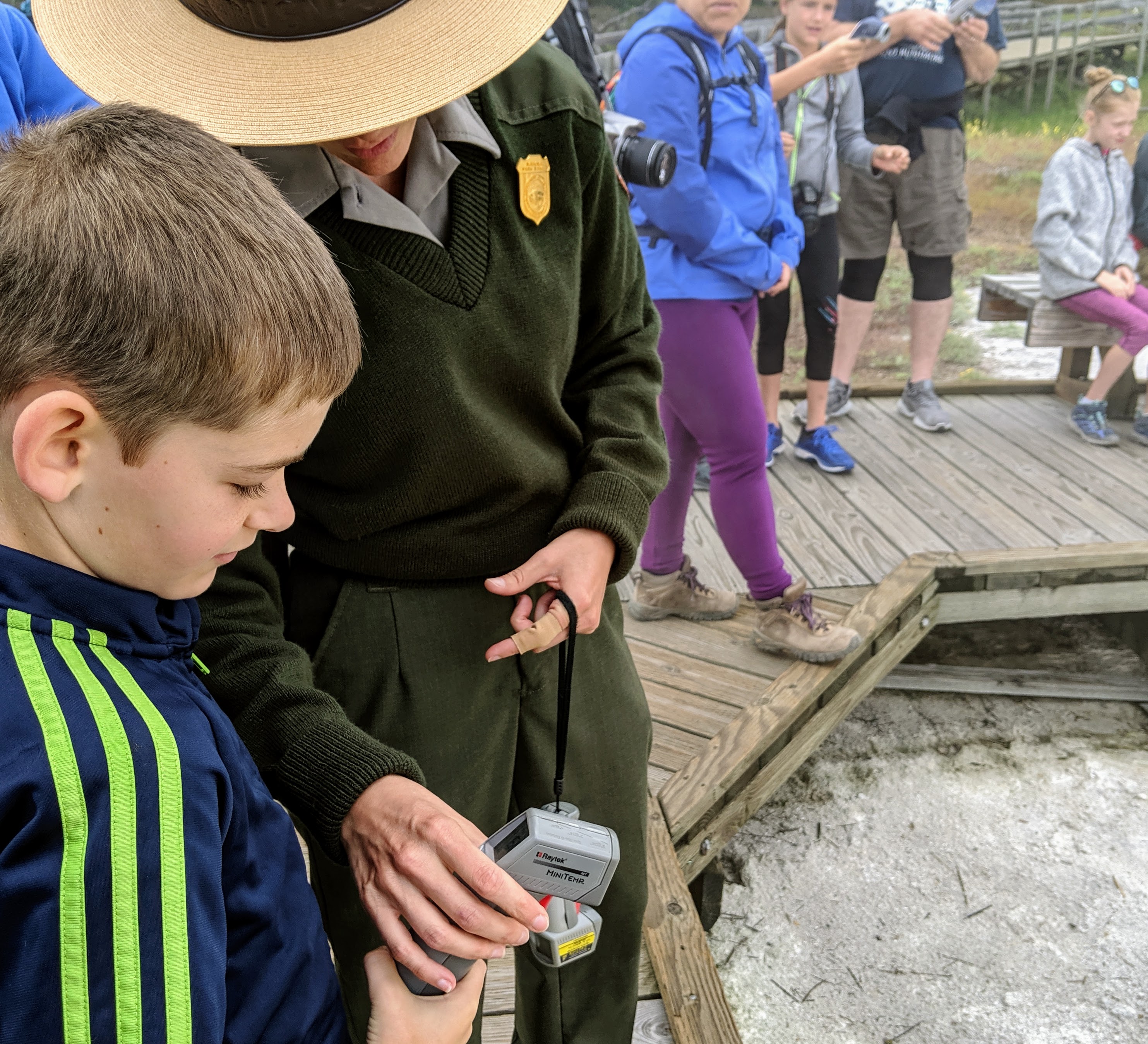 Ranger programs at Yellowstone National Park. this ranger is helping my grandson test the temperature of one of the many springs