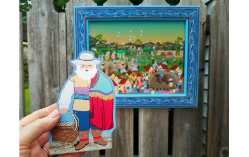 Colonial Mexico Santa shown with the painting from Mexico that inspired Faline for his design.