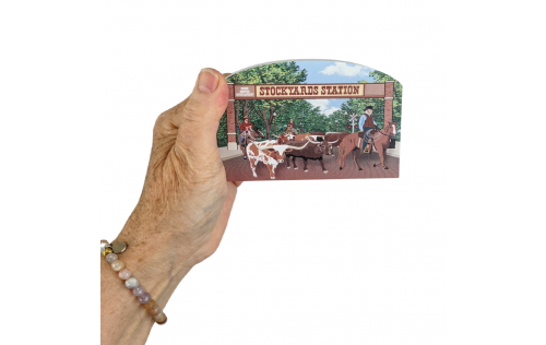 Wooden replica of the Fort Worth Herd Cattle Drive that happens daily in Fort Worth, Texas. Handcrafted by The Cat's Meow Village in the USA.