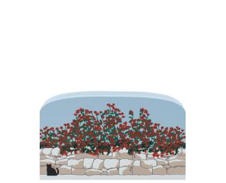 Roses cascading over a stone wall handcrafted in 3/4" thick wood by The Cat's Meow Village in the USA.