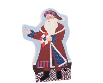 Red, White and Blue Santa is stitching up a patriotic 9 patch quilt block. Handcrafted in Wooster, Ohio by The Cat's Meow Village.