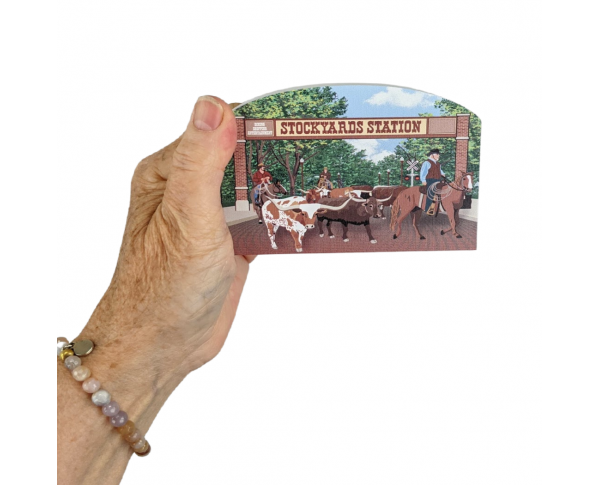 Wooden replica of the Fort Worth Herd Cattle Drive that happens daily in Fort Worth, Texas. Handcrafted by The Cat's Meow Village in the USA.